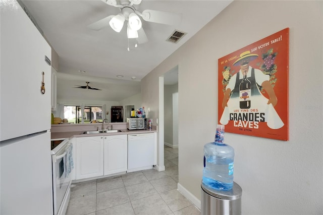 kitchen with white appliances, light tile patterned flooring, sink, white cabinetry, and ceiling fan