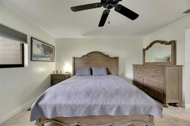 tiled bedroom featuring ceiling fan