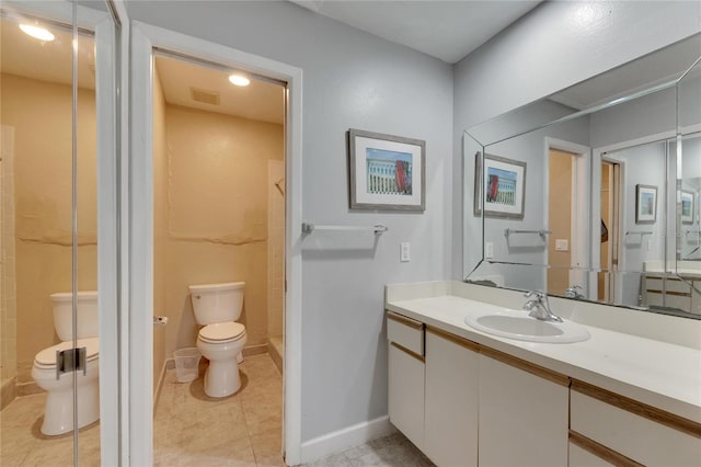 bathroom with toilet, vanity, a shower, and tile patterned floors