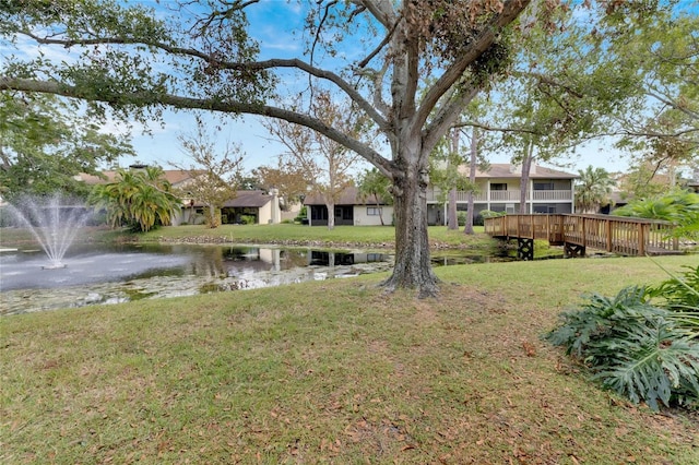 view of yard with a deck with water view