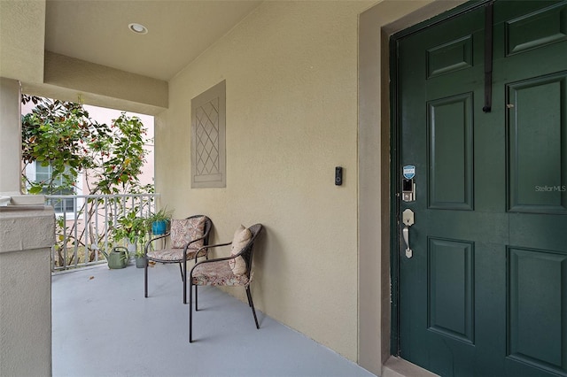 property entrance featuring stucco siding