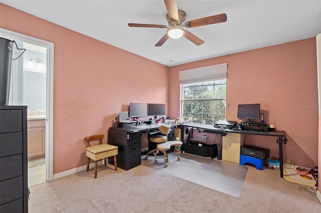 office area featuring light carpet and ceiling fan