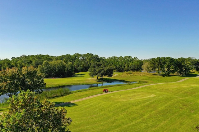 surrounding community featuring a water view, golf course view, and a yard