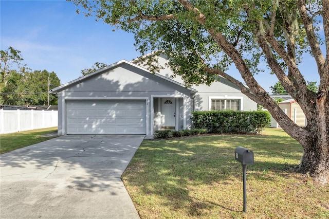 ranch-style house featuring a front yard and a garage