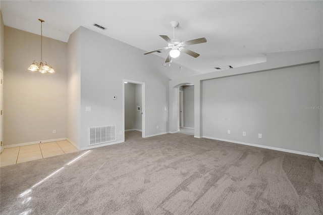 carpeted spare room with high vaulted ceiling and ceiling fan with notable chandelier