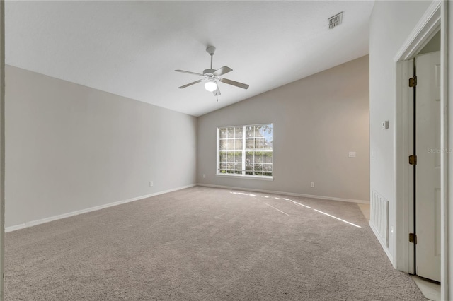 spare room with ceiling fan, light colored carpet, and lofted ceiling