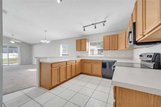 kitchen featuring light tile patterned floors, range, decorative light fixtures, and dishwasher