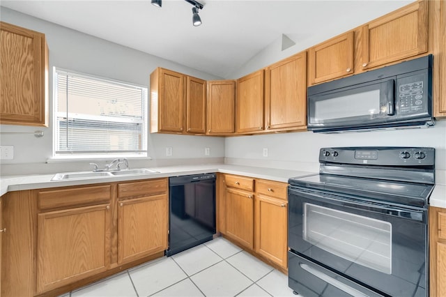 kitchen featuring light tile patterned flooring, sink, black appliances, and lofted ceiling