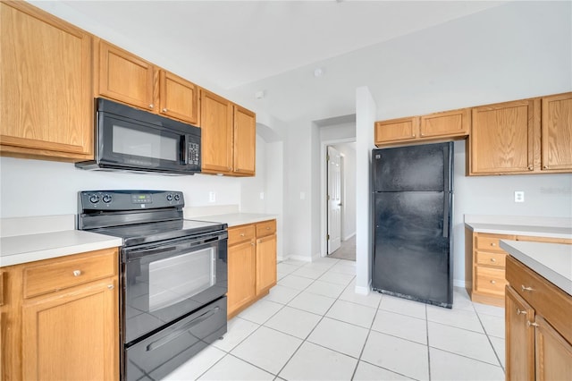 kitchen featuring black appliances and light tile patterned flooring