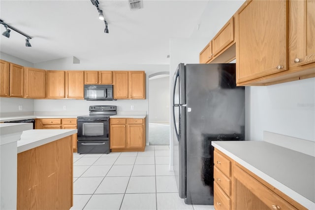 kitchen featuring black appliances, light tile patterned floors, and rail lighting