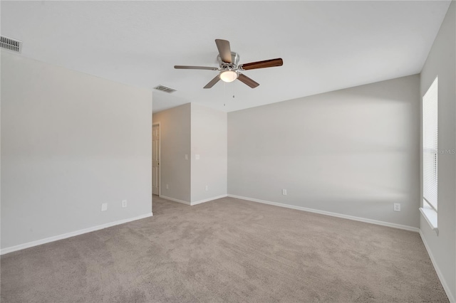 unfurnished room with light colored carpet and ceiling fan