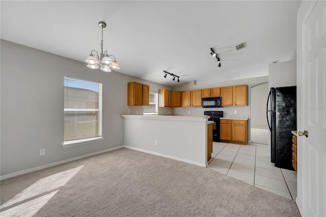 kitchen featuring kitchen peninsula, black appliances, light carpet, rail lighting, and decorative light fixtures