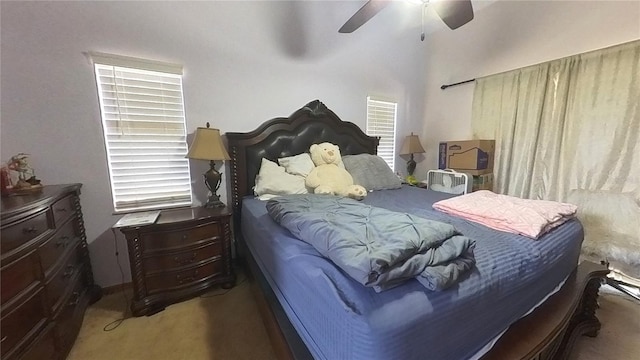 carpeted bedroom featuring multiple windows and ceiling fan