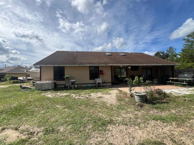 back of house featuring a yard and a patio area