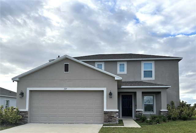 view of front of house with a front yard and a garage