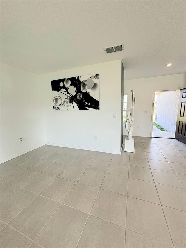 spare room with light tile patterned floors