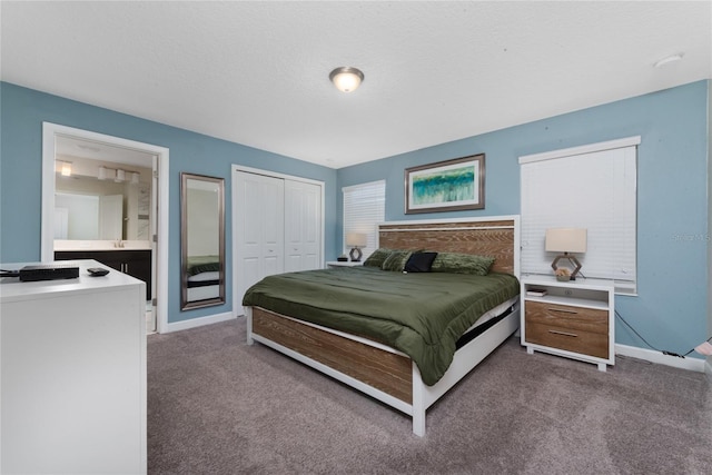 carpeted bedroom featuring a closet and a textured ceiling