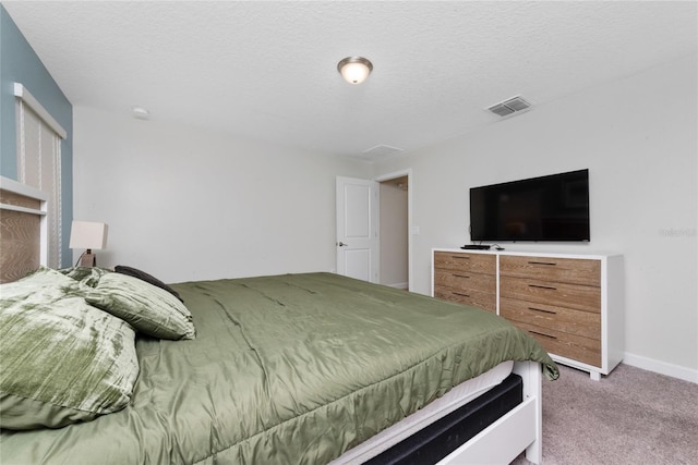 carpeted bedroom with a textured ceiling