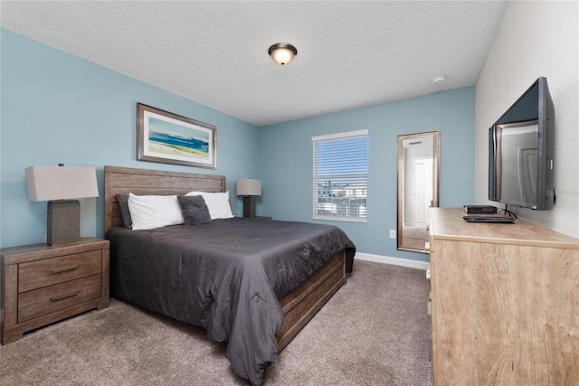 bedroom featuring a textured ceiling and carpet floors