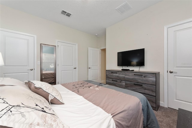 carpeted bedroom with a textured ceiling