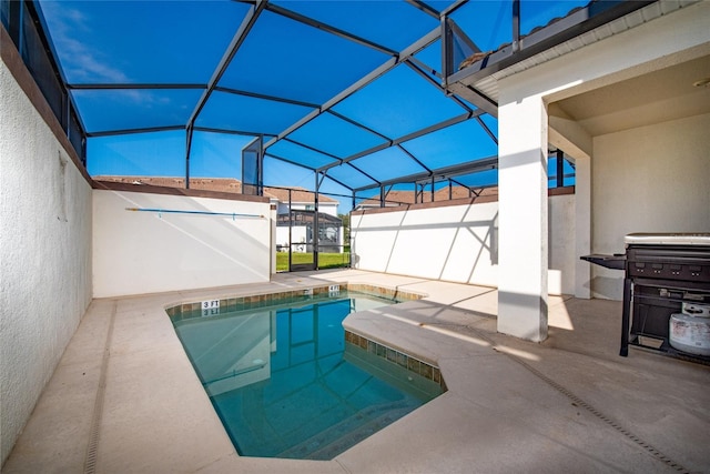 view of pool featuring a patio and glass enclosure