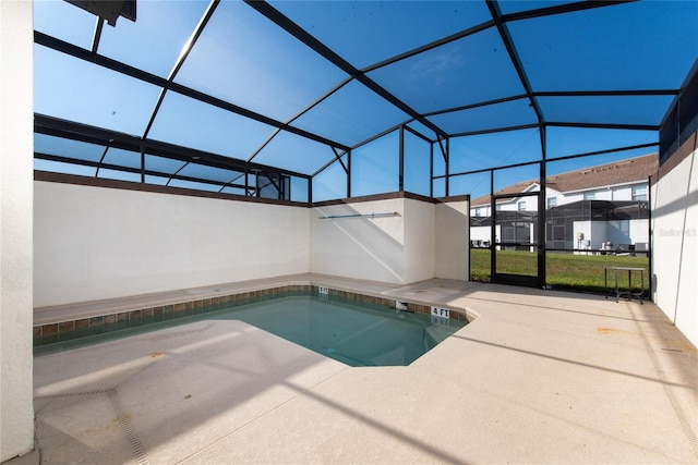 view of swimming pool featuring a patio area and glass enclosure