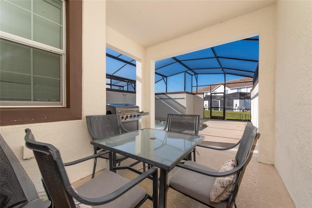 view of patio with area for grilling and a lanai