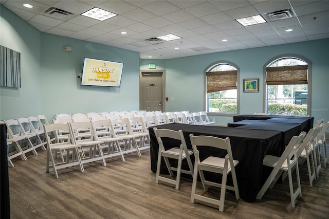 dining area featuring a paneled ceiling and hardwood / wood-style flooring