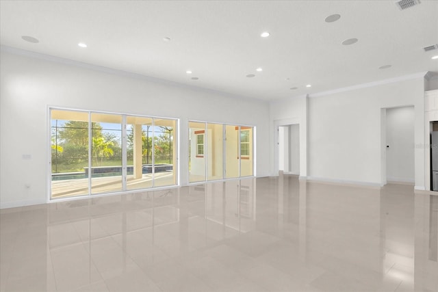 tiled empty room featuring crown molding