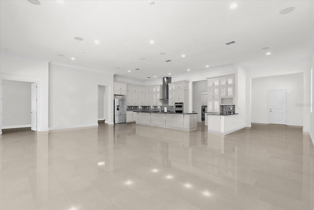 unfurnished living room featuring crown molding and light tile patterned floors