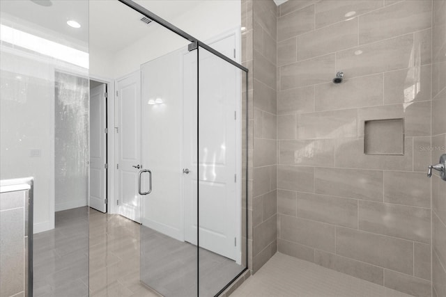 bathroom with tile patterned floors and an enclosed shower