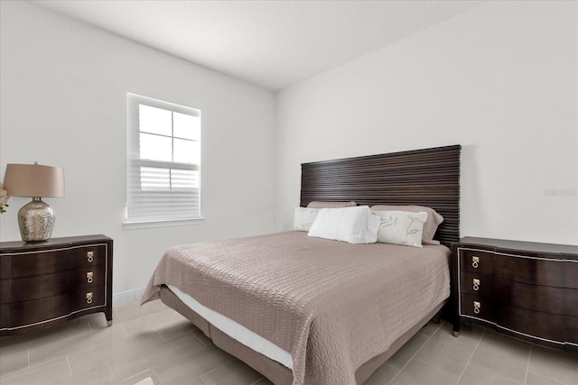 bedroom featuring light tile patterned floors