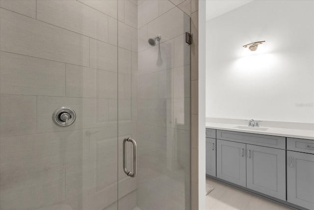 bathroom with a shower with door and vanity