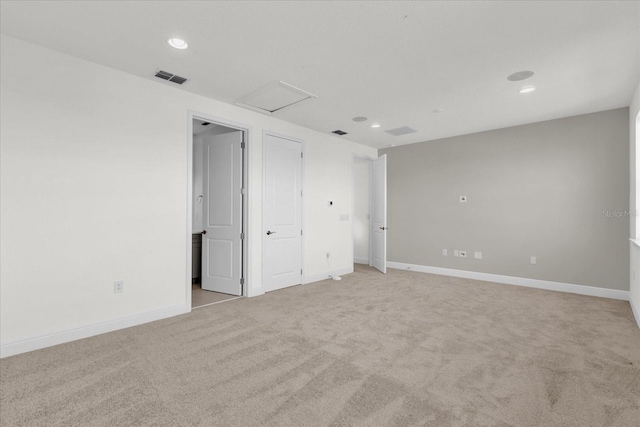 unfurnished room with light carpet