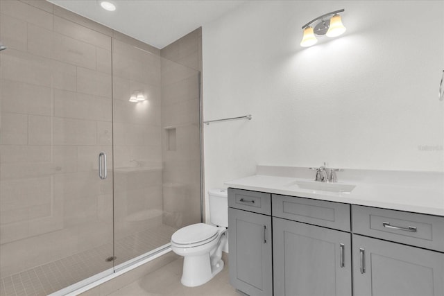 bathroom featuring vanity, toilet, and an enclosed shower