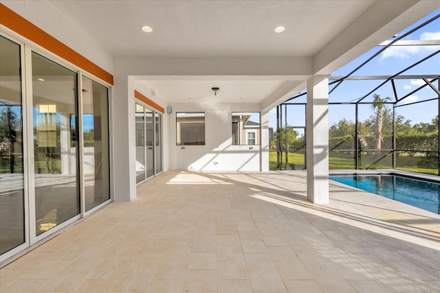 view of swimming pool with a patio area and a lanai