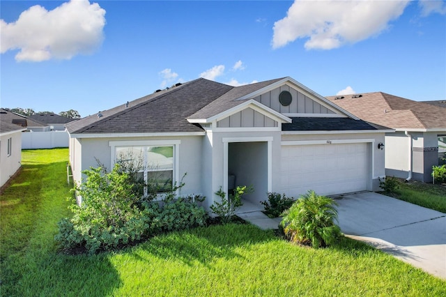 view of front of property with a front yard and a garage