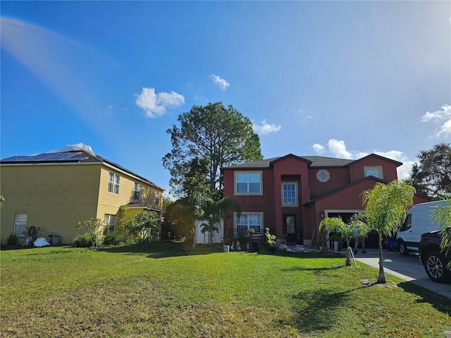 view of front of home with a front lawn and solar panels