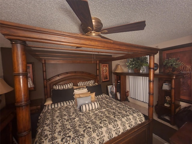 bedroom with ceiling fan and a textured ceiling