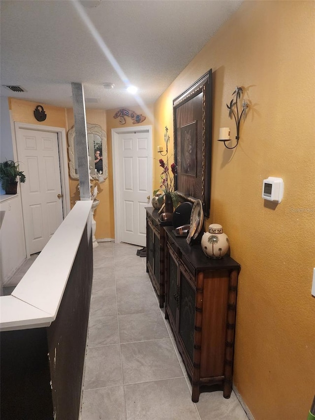 corridor with light tile patterned floors