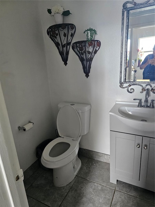 bathroom featuring toilet, vanity, and tile patterned floors