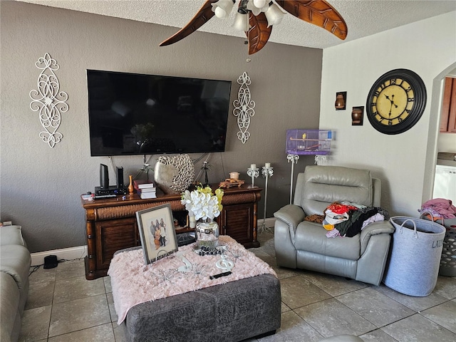 tiled living room featuring a textured ceiling