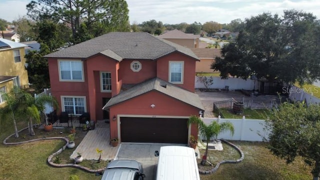 view of front facade with a front yard and a garage