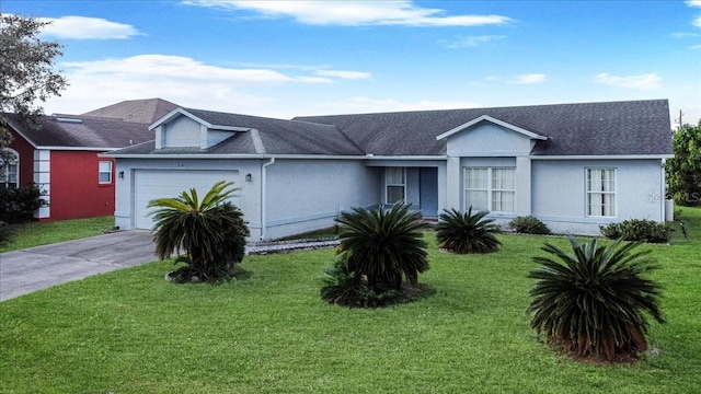 ranch-style house featuring a garage and a front lawn