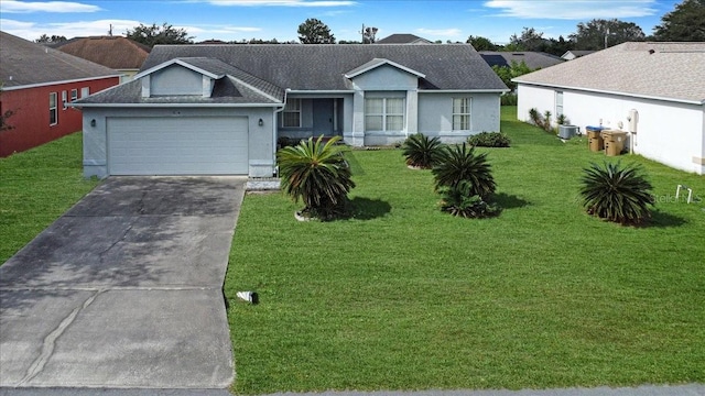 ranch-style home with cooling unit, a garage, and a front lawn