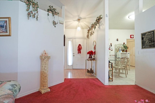 entryway featuring light colored carpet and a textured ceiling