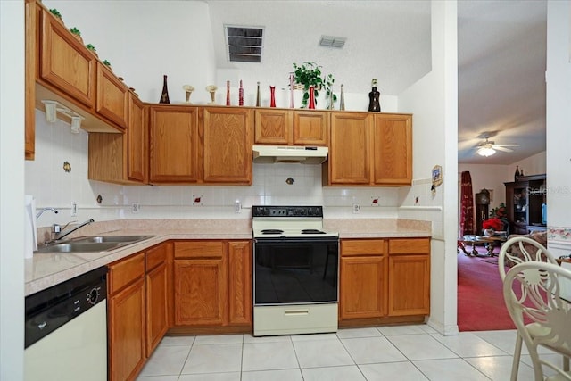 kitchen featuring sink, tasteful backsplash, electric range oven, light tile patterned floors, and dishwashing machine