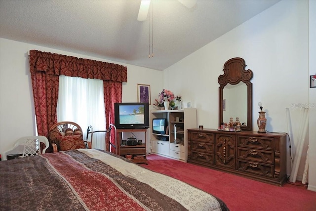 carpeted bedroom featuring ceiling fan, vaulted ceiling, and a textured ceiling