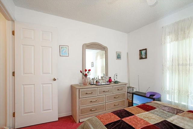 bedroom with carpet flooring and a textured ceiling