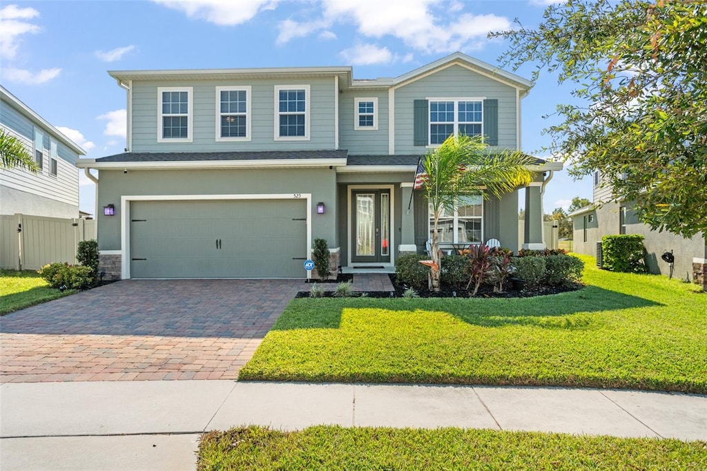 view of front of property with a front yard and a garage